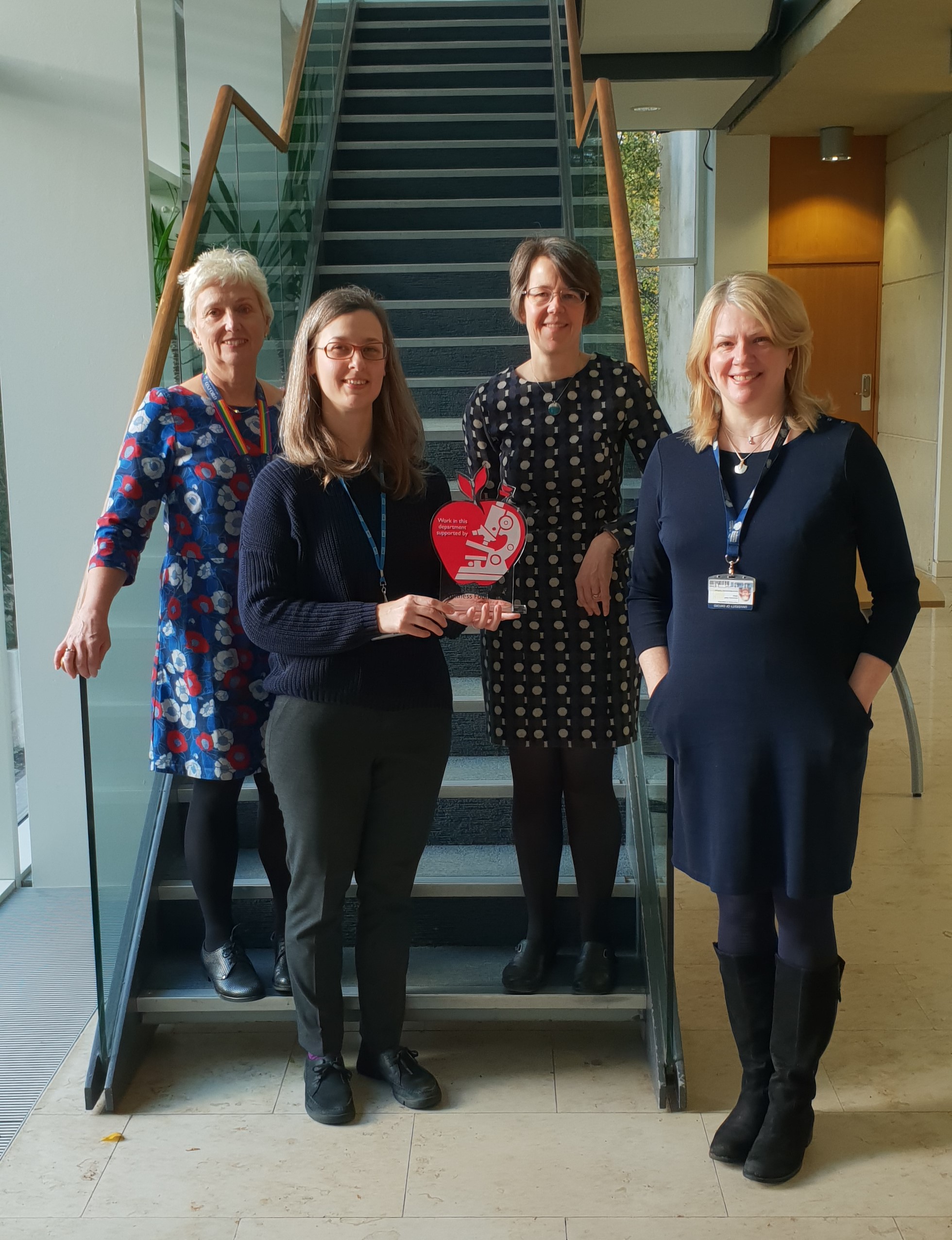 A group of DRWF funded researchers holding our research funding award.  