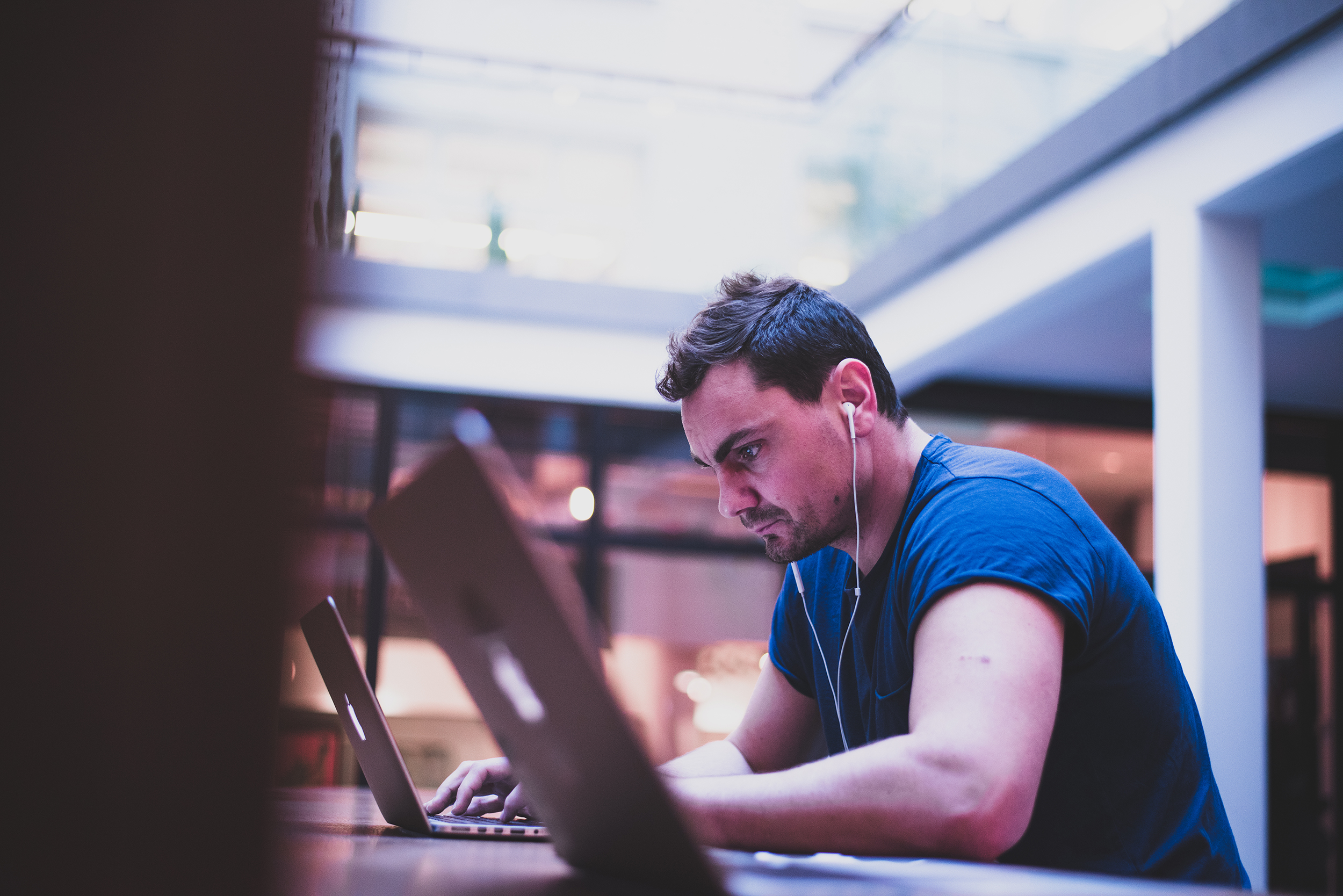 Peter working on a laptop at a workstation 