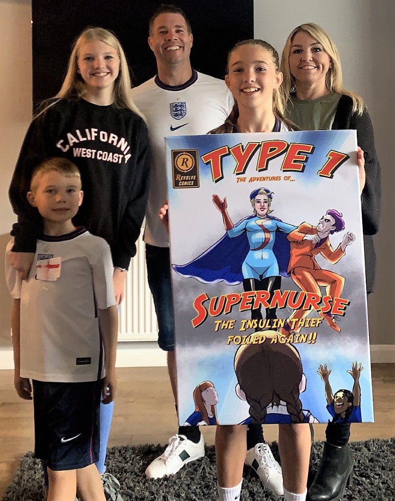 Xanthe and her family with her artwork 