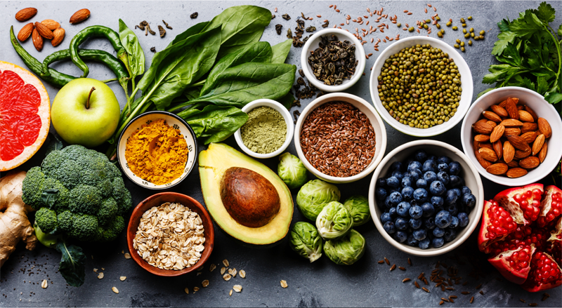 A group of food and vegetables on a table. 