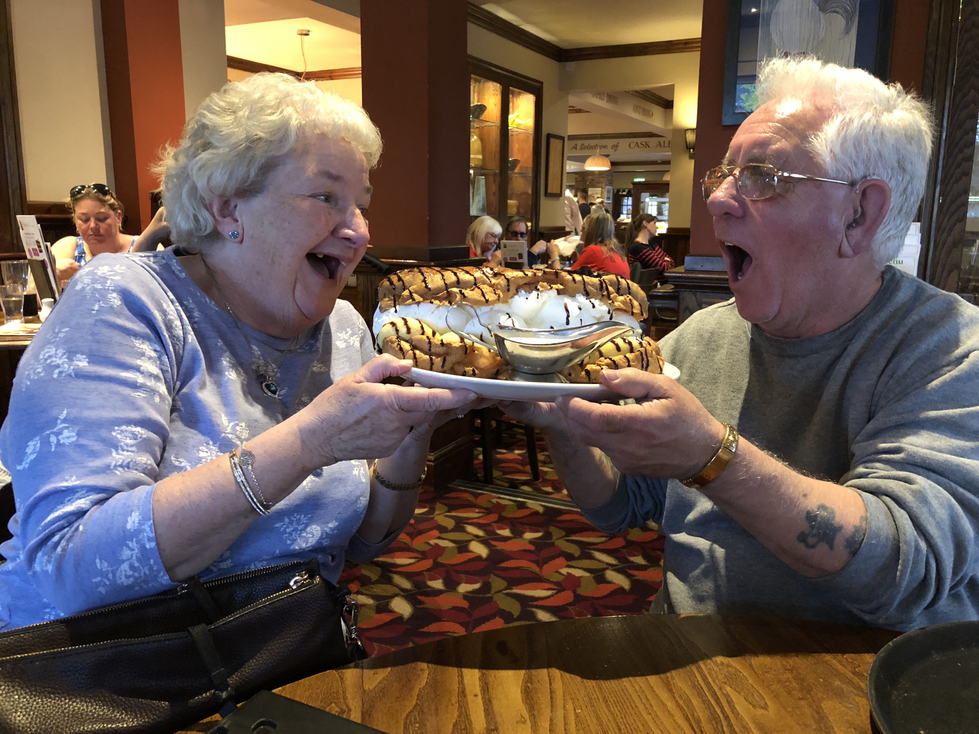 Pauline and Lionel posing with eclairs. 