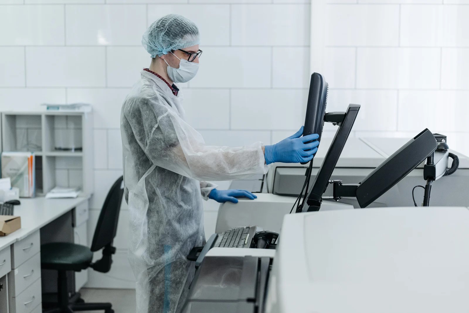 A man wearing protective clothing in a laboratory. 