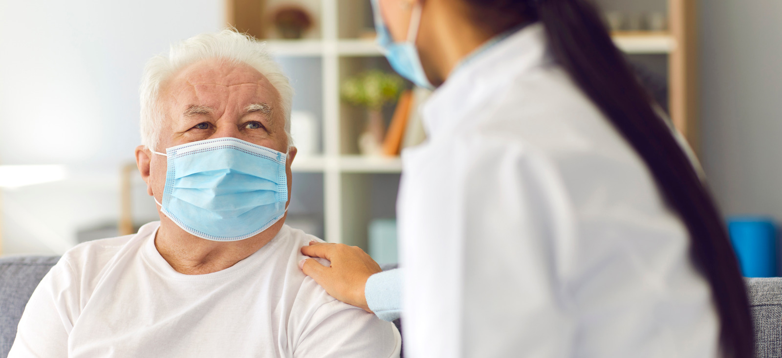 Elderly Patient And Healthcare Professional Wearing Masks